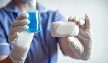The doctor holds in hands personal protective equipment against the spread of the Corona covid-19 virus.の写真素材