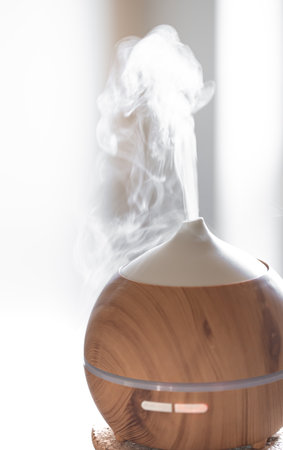 Aroma oil diffuser lamp on a table. Aromatherapy and health care concept.の写真素材