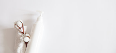Detergent with dispenser, towel and cotton sprig flat lay. Body care concept.の写真素材