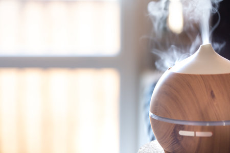 Aroma oil diffuser lamp on a table close up. Aromatherapy and health care concept.の写真素材