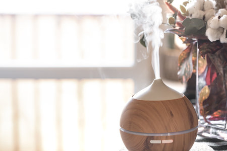 Aroma oil diffuser lamp on a table. Aromatherapy and health care concept.の写真素材