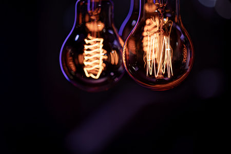 Luminous lamps hang in the dark from the boke. Decor and atmosphere concept.