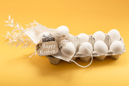 Chicken egg tray and protective medical mask. Happy easter concept during coronavirus pandemic.