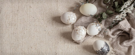Beautiful Easter eggs scattered on the textured fabric. Easter decor concept.