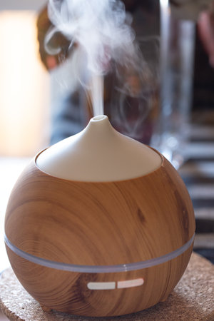 Aroma oil diffuser lamp on a table. Aromatherapy and health care concept.の写真素材
