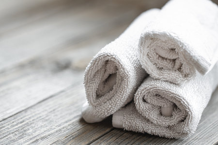 Close up of rolled bath towels on blurred background. Health and personal hygiene concept.の写真素材
