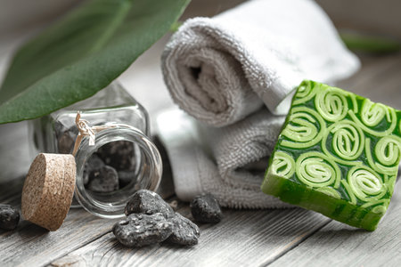 Spa still life with stones in a jar, handmade soap and towels. Health and beauty concept.の写真素材