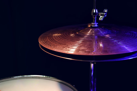 Part of a drum kit in the dark with beautiful lighting. Concert and performance concept.