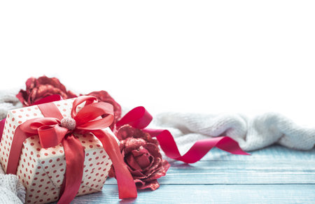Beautifully wrapped valentine's day gift and decor elements on a wooden surface close up.の写真素材