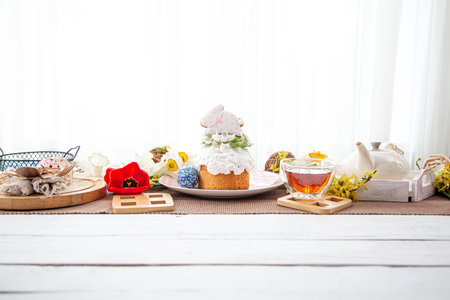Easter composition with cake, tea and flowers. The concept of a festive tea party.