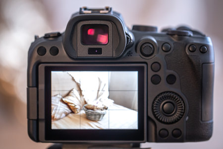 Close up professional digital camera on a tripod on a blurred background. The concept of technology for working with photos and videos.の写真素材