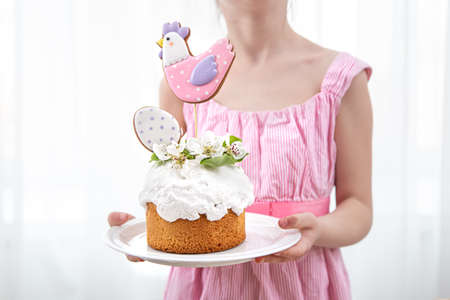 Festive Easter cake decorated with flowers and bright elements. The concept of preparing for the Easter holiday.の写真素材