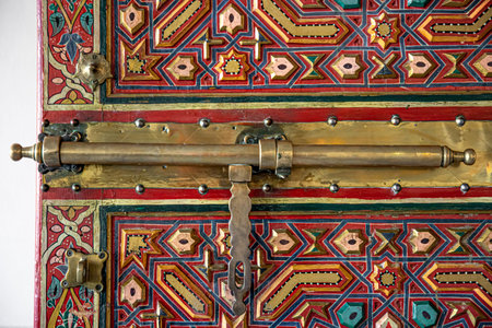 Close up of the bolt on old doors in oriental style with many details.