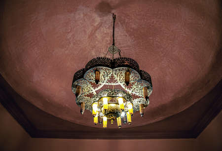Close up of a chandelier on the ceiling with a traditional oriental style with many details.の写真素材