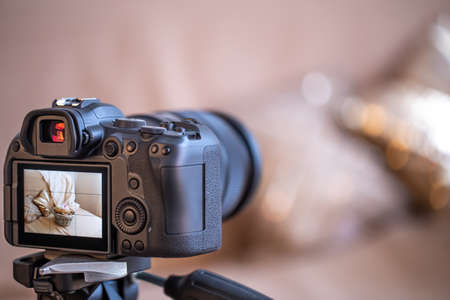 Close up professional digital camera on a blurred background. The concept of technology for working with photos and videos.の写真素材