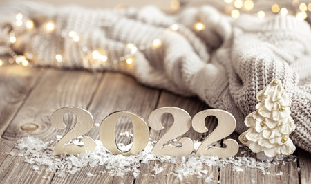 Christmas still life with decorative number of the coming year with decor details on blurred...