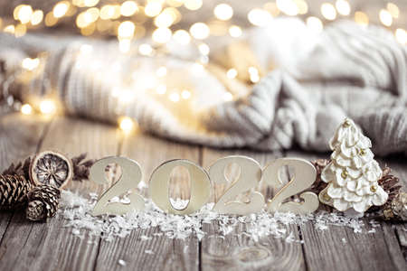 Christmas still life with decorative number of the coming year on a wooden surface against a blurred background.の写真素材