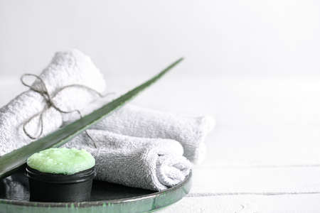 Spa still life with organic skincare, fresh aloe leaf and towels. The concept of beauty and organic cosmetics.の写真素材