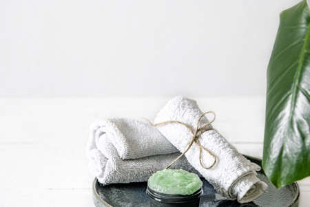 Spa still life with organic skincare, natural leaf and towels. The concept of beauty and organic cosmetics.の写真素材