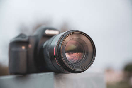 Close up of a professional SLR camera on a blurred background copy space.の写真素材
