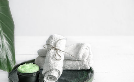 Spa still life with organic skincare, natural leaf and towels. The concept of beauty and organic...