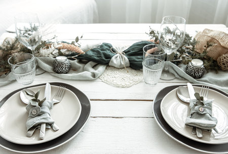 Festive table setting at home with Scandinavian decorative details close up.