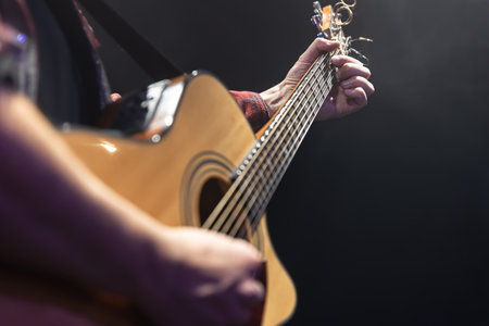 Classical acoustic guitar in the hands of a musician copy space.の写真素材