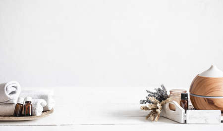 Spa still life with air humidifier and natural aromatic oil towels.の写真素材