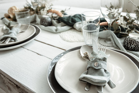 Festive table setting at home with Scandinavian decorative details close up.