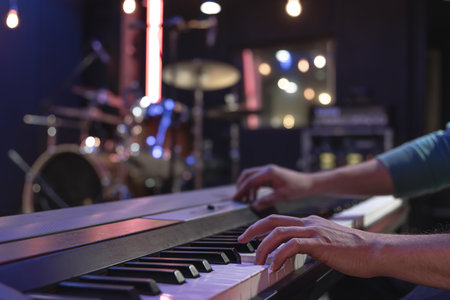 Close up of pianist's hand on musical keys on blurred background.の写真素材