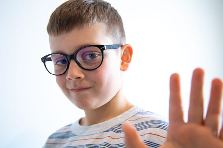 Portrait of a cute elementary school student wearing glasses.の写真素材