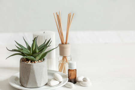 Close-up of an aroma stick for a room smell and a jar of aromatic oil.の写真素材