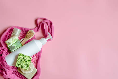 Flat lay spa composition with personal hygiene items and bath accessories in a string bag.の写真素材