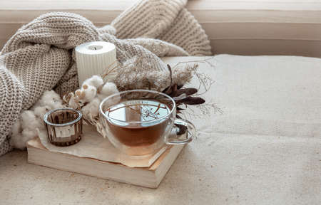 Still life in the Scandinavian style with a cup of tea, a knitted element and a book copy space.の写真素材