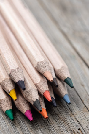 Close-up set of colored pencils for drawing on blurred background.