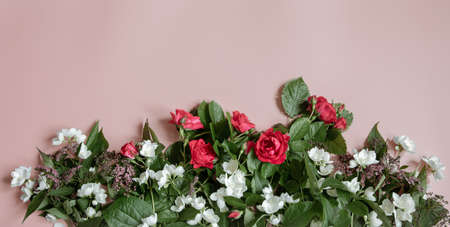 Flat lay composition with fresh flowers on pink background.の写真素材