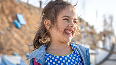 A funny little girl saw something funny in the distance.の写真素材