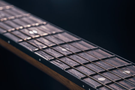 Part of an acoustic guitar, guitar fretboard on a black background.の写真素材