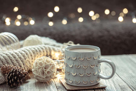 Christmas background with a beautiful cup and decor details on a blurred background with bokeh.の写真素材