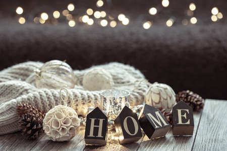 Close up of wooden letters make the word home, details of Christmas decor on blurred background with bokeh.の写真素材