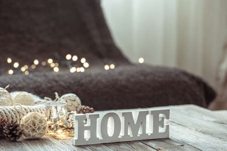 Close-up of decorative word home, details of Christmas decor on blurred background with bokeh.の写真素材