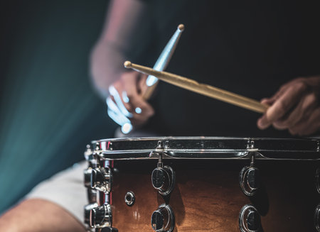 A man plays with sticks on a drum, a drummer plays a percussion instrument, copy space.の写真素材