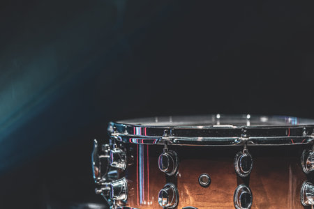 Close-up of a snare drum, percussion instrument on a dark background with haze, beautiful lighting.