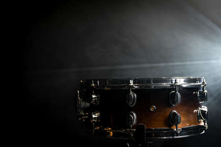 Snare drum, percussion instrument against the backdrop of a bright stage spotlight.の写真素材