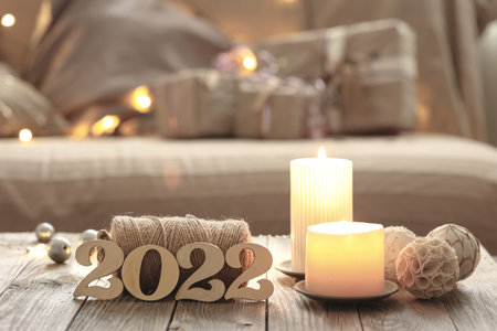 Home Christmas composition with decorative wood 2022 numbers, candles, and decor details on a...