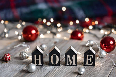 Winter composition with the decorative word home and Christmas balls on a blurred background with bokeh.の写真素材