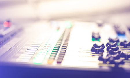 Sound mixer. Professional audio mixing console with lights, buttons, faders and sliders.