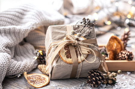 Festive Christmas background with gift box on blurred background with decor details.