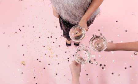 Glasses with champagne in the hands of girls at a party, top view.の写真素材
