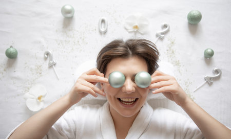 Young woman in spa salon, top view, Christmas festive concept.